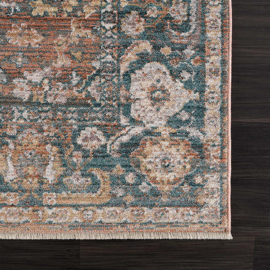 Close-up of the Mele Area Rug showing its traditional burnt orange, brown, gray, and beige floral pattern and cotton texture. Swatch