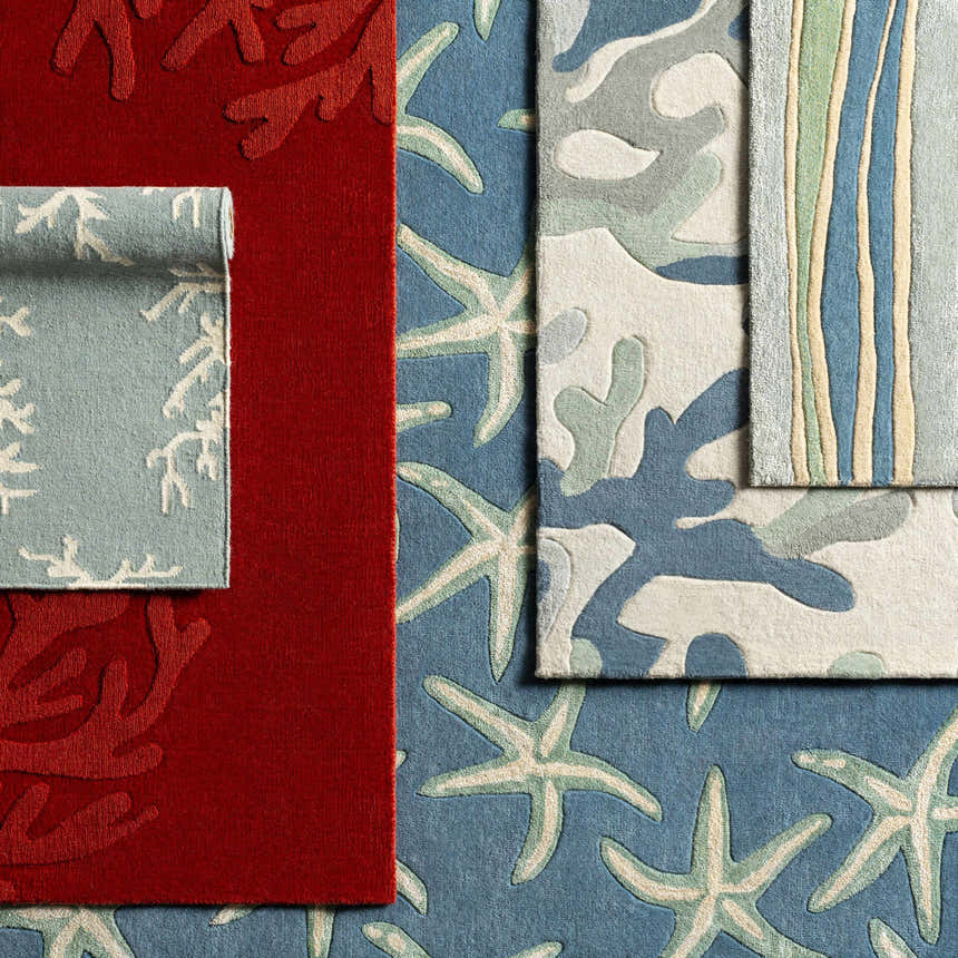 Close-up of Carversville Ice Blue Botanical Wool Rug showing botanical, starfish, and striped patterns in blue, ivory, and red. Styleshot