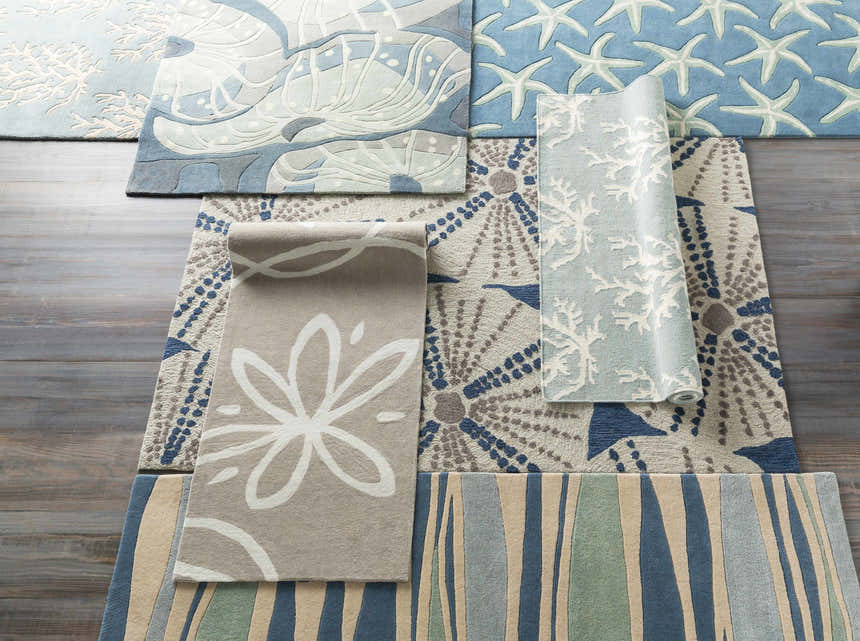 Assorted wool rugs: Carversville Ice Blue botanical, starfish, coral, floral, and striped designs in ivory, light blue, and beige. Styleshot