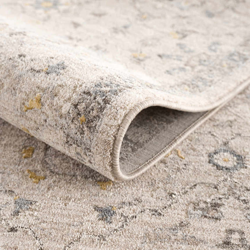 Close-up of Annie Cream Textured Rug showing its soft pile, floral pattern, and neutral colors. Fold