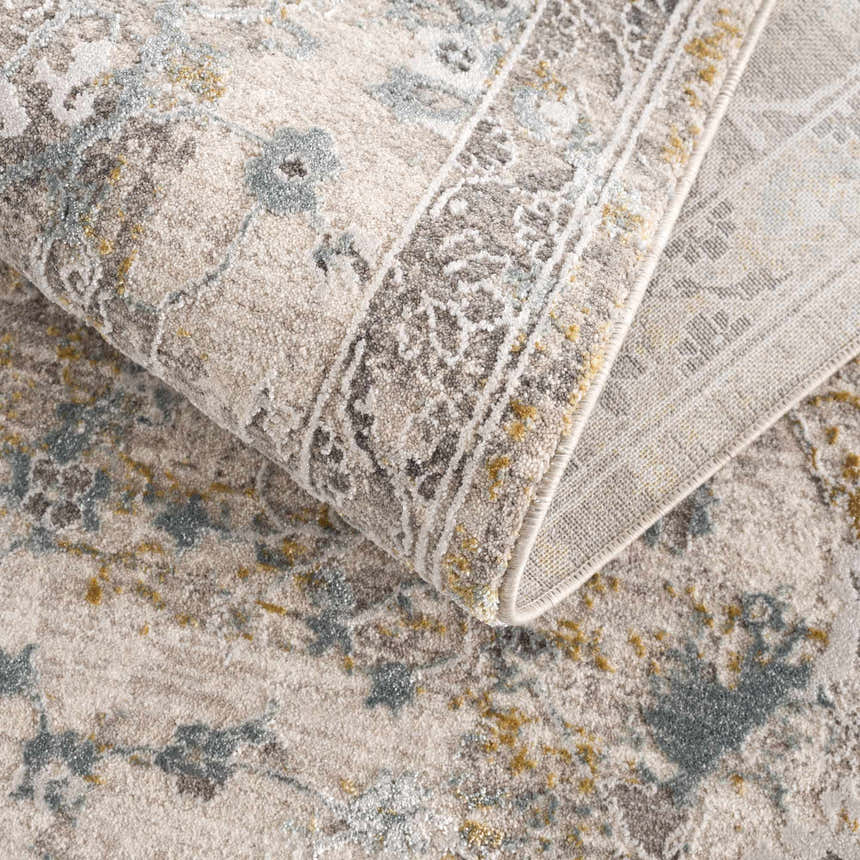 Close-up of the textured Alroy Rug. Floral pattern in gray, brown and nutmeg. Farmhouse style with a soft, cozy feel. Fold