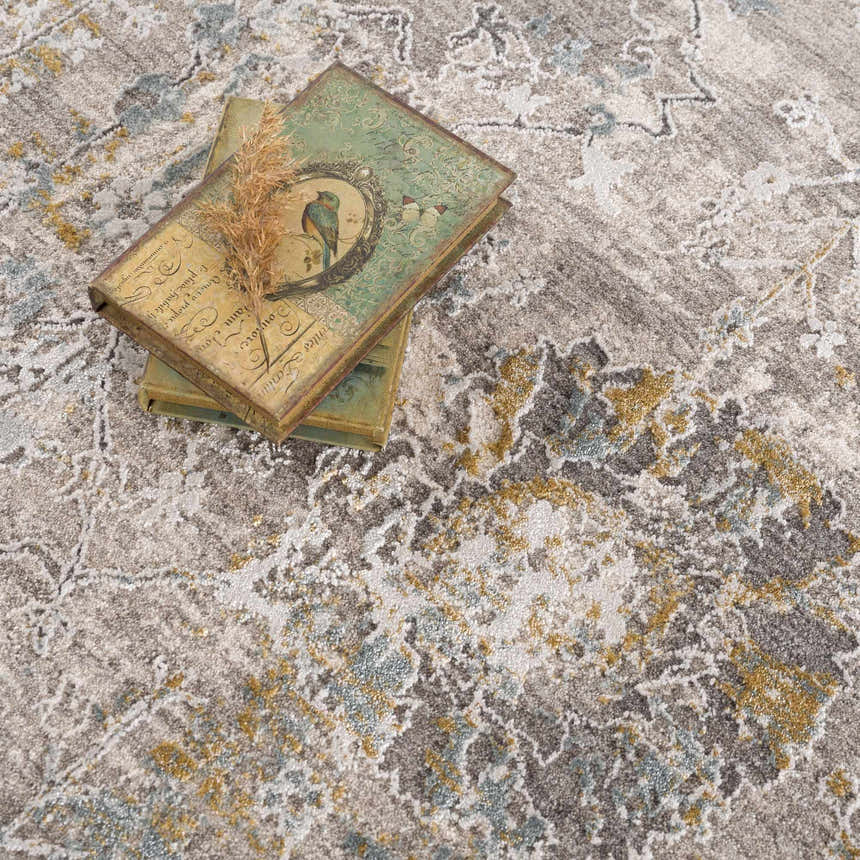 Close-up of the Alroy Textured Rug. Features a gray, brown, and gold abstract pattern and soft, textured pile. Styleshot