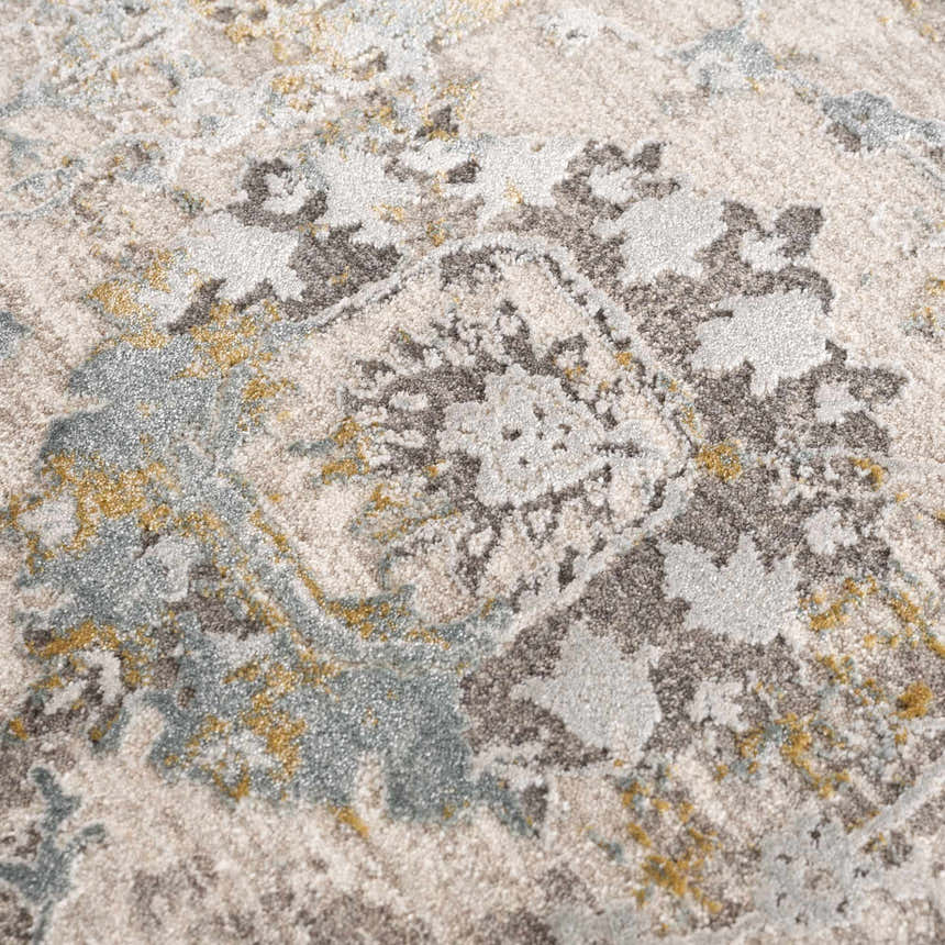 Close-up of the Alroy Textured Rug. Features a gray, brown, and natural abstract pattern with a soft, textured pile. Texture