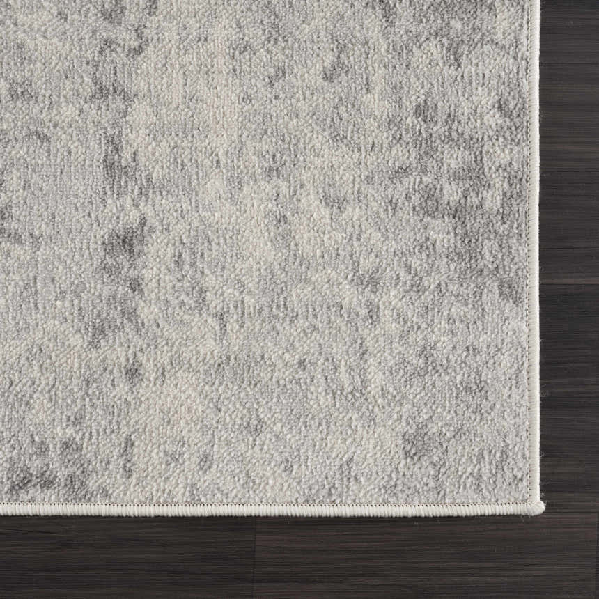 Close up of Tigrima Ivory 2319 area rug showing gray and ivory contemporary pattern and texture on dark wood floor. Swatch