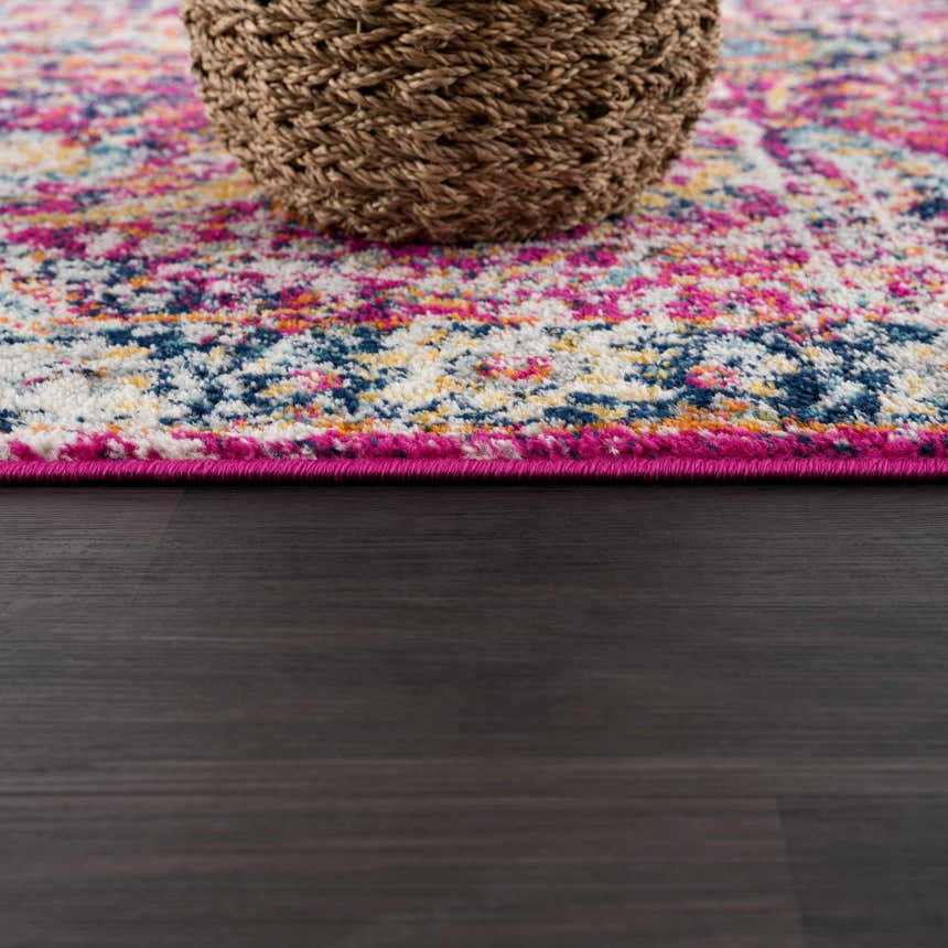 Close up of the New Vick Area Rug showing its pink, blue, and yellow traditional pattern. Pile