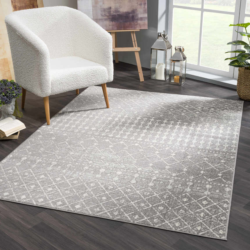 Living room scene with ivory chair and gray Marash KMRSH-4607 area rug featuring a contemporary geometric pattern. Roomscene-Rectangle