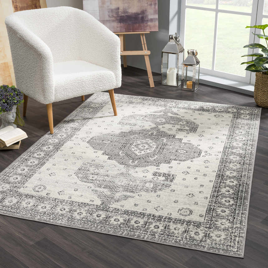 Living room scene with Marash 4605 Gray Area Carpet, ivory chair, and dark wood floors. Contemporary, farmhouse style. Roomscene-Rectangle