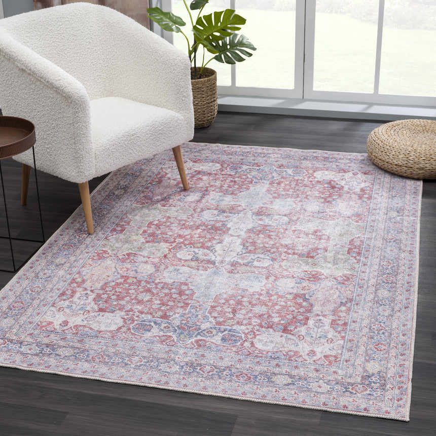 Living room scene with Rust Goma Vintage Area Rug, cream chair, and natural light. The rug adds a touch of bohemian style. Roomscene-Rectangle