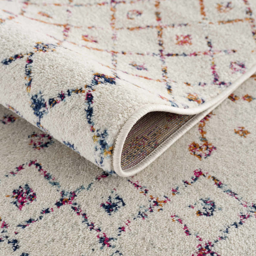 Close-up of the Marash KMRSH-4600 area rug. Off-white rug with blue, red, and orange geometric pattern and rolled edge. Fold