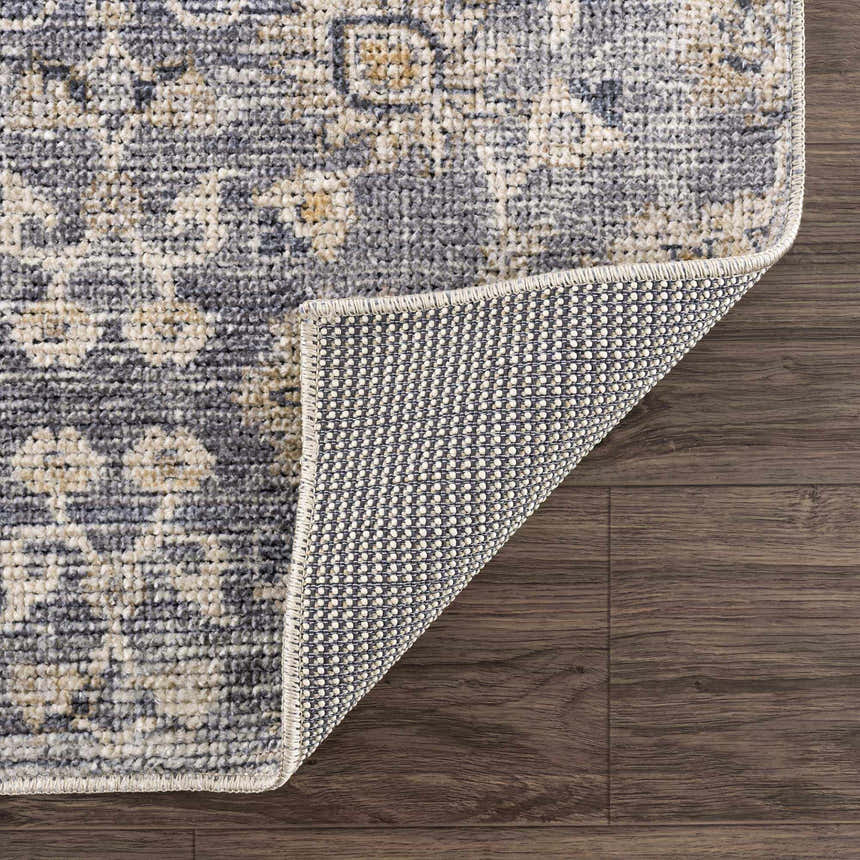 Close-up of the Metin Area Rug showing the light gray and natural gray traditional pattern and machine woven construction. Fold