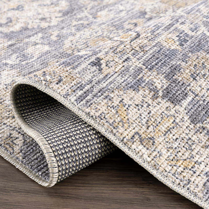 Close up of the Metin Area Rug, a light gray and natural gray farmhouse style rug. Fold