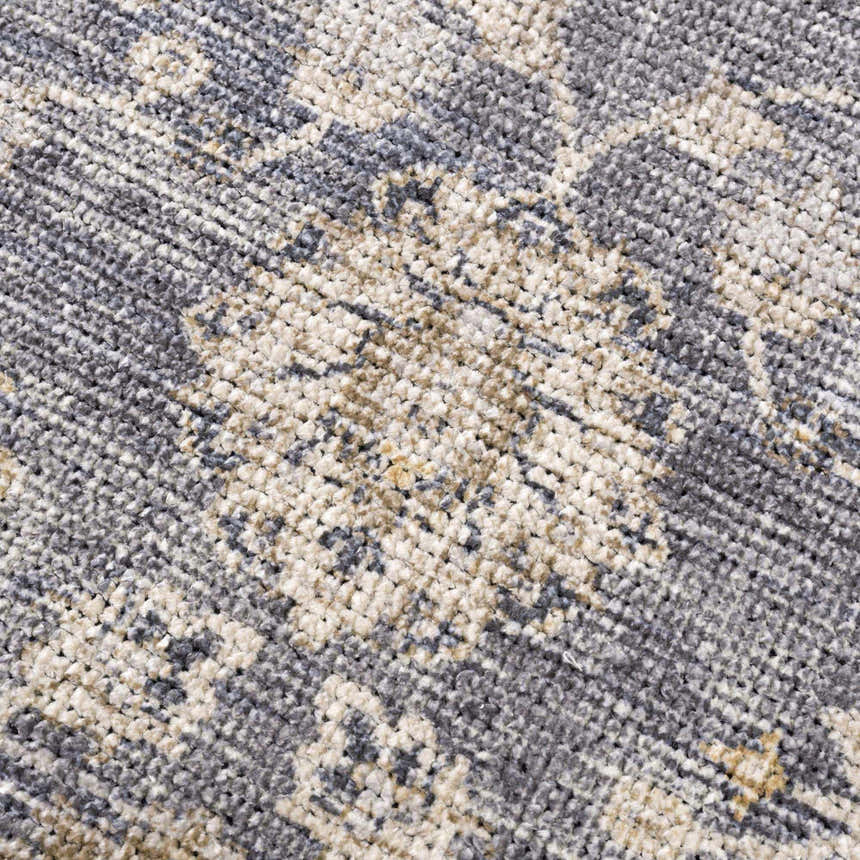 Close-up of the Metin Area Rug, showing its light gray and natural gray farmhouse pattern and textured, machine-woven construction. Texture