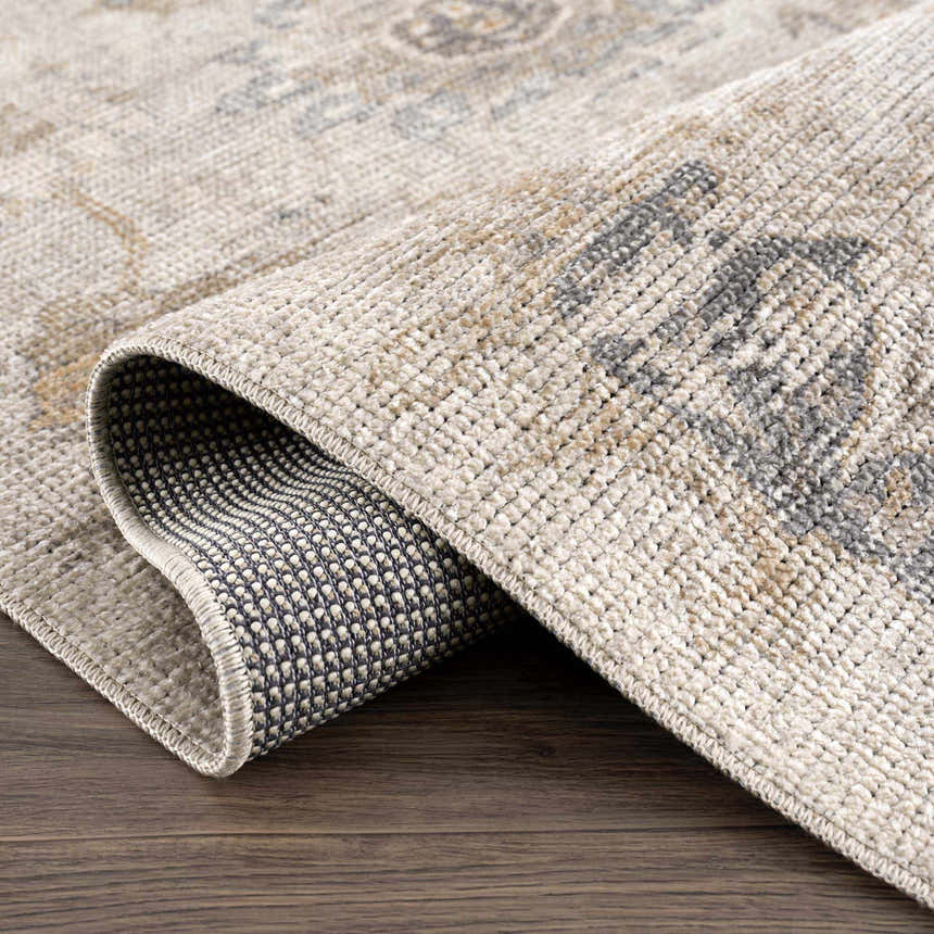 Close-up of the Melor Area Rug showing the traditional vintage pattern, soft texture, and durable backing. Fold