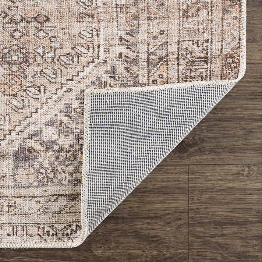 Close-up of Nadie Beige Medallion Area Rug showing its traditional pattern, neutral colors, and the rug's backing. Fold