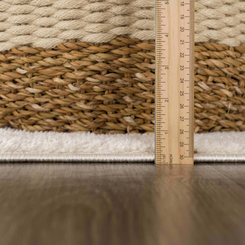 Close up of the Keanu Area Rug showing its texture, pile height, and beige, brown and off-white colors. Pile