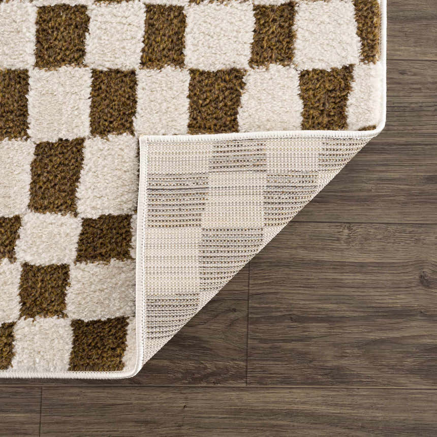 Close-up of the Lajos Brown Checkered Shag Rug showing the brown and beige checkered pattern and rug backing. Fold