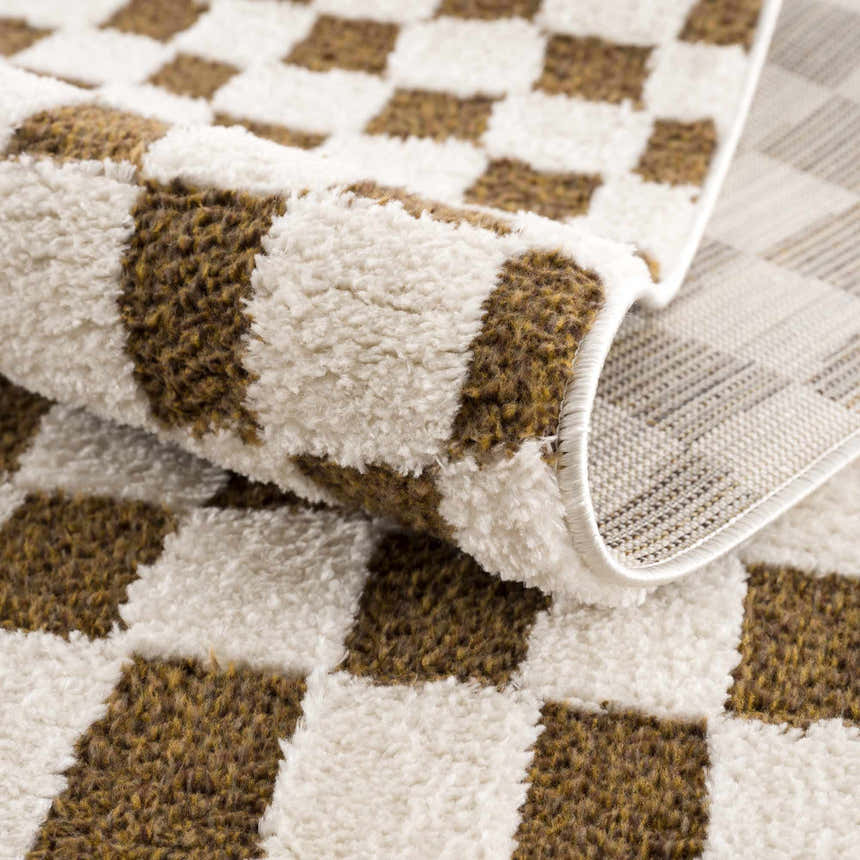 Close-up of the Lajos Brown Checkered Shag Rug, showing its brown and beige checkered pattern and soft, textured pile. Fold