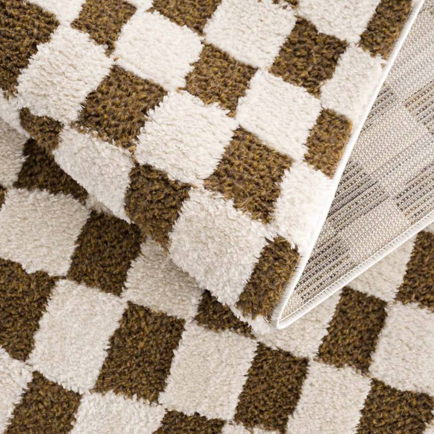 Close-up of the Lajos Brown Checkered Shag Rug. Features a beige and brown checkered pattern with a soft, shag texture. Fold