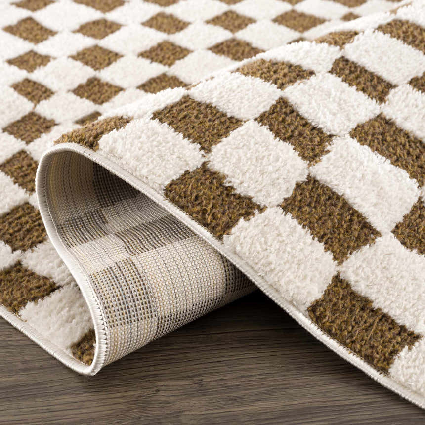 Close-up of the Lajos Brown Checkered Shag Rug showing its brown and beige checkered pattern and soft, shag texture. Fold
