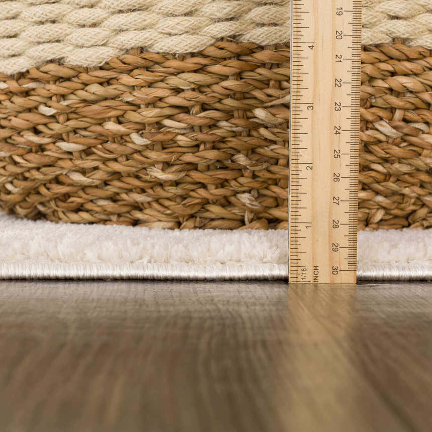Close-up of Mahsa Area Rug showing cream pile height and woven texture with a ruler for scale. Pile
