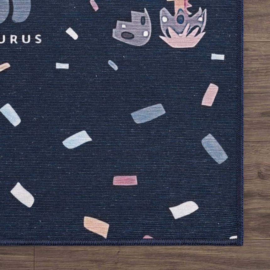 Close-up of the Milne Navy Dinosaur Washable Kids Rug, featuring a navy background with dinosaur shapes and colorful confetti accents. Corner