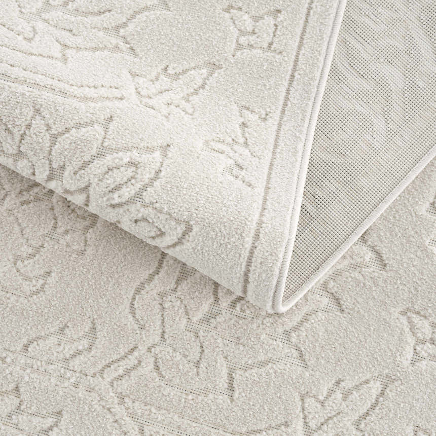 Close-up of the Off White Senekal 3D Outdoor Area Rug showing its geometric pattern and textured weave. Fold