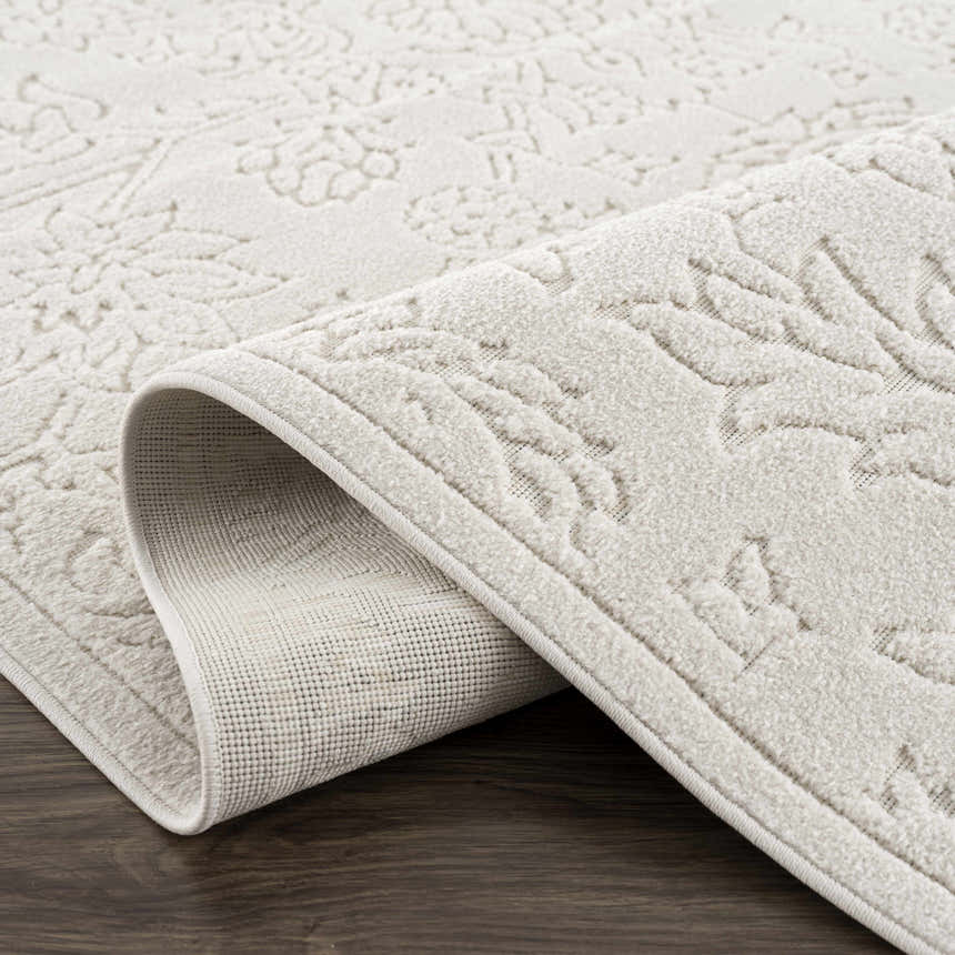 Close-up of the Senekal 3D Outdoor Area Rug in off white, showing the geometric pattern and textured pile. Fold