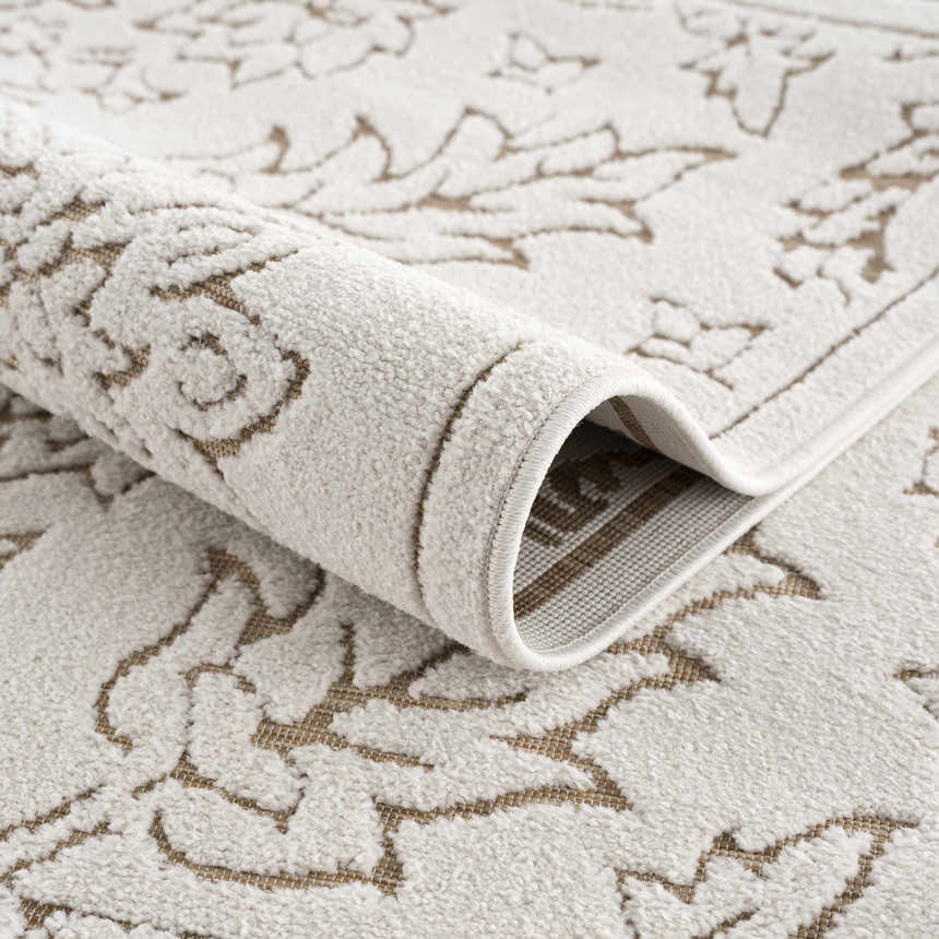 Close-up of the Tabuan 3D Outdoor Area Rug showing its gray and light peach floral pattern and textured polypropylene material. Fold