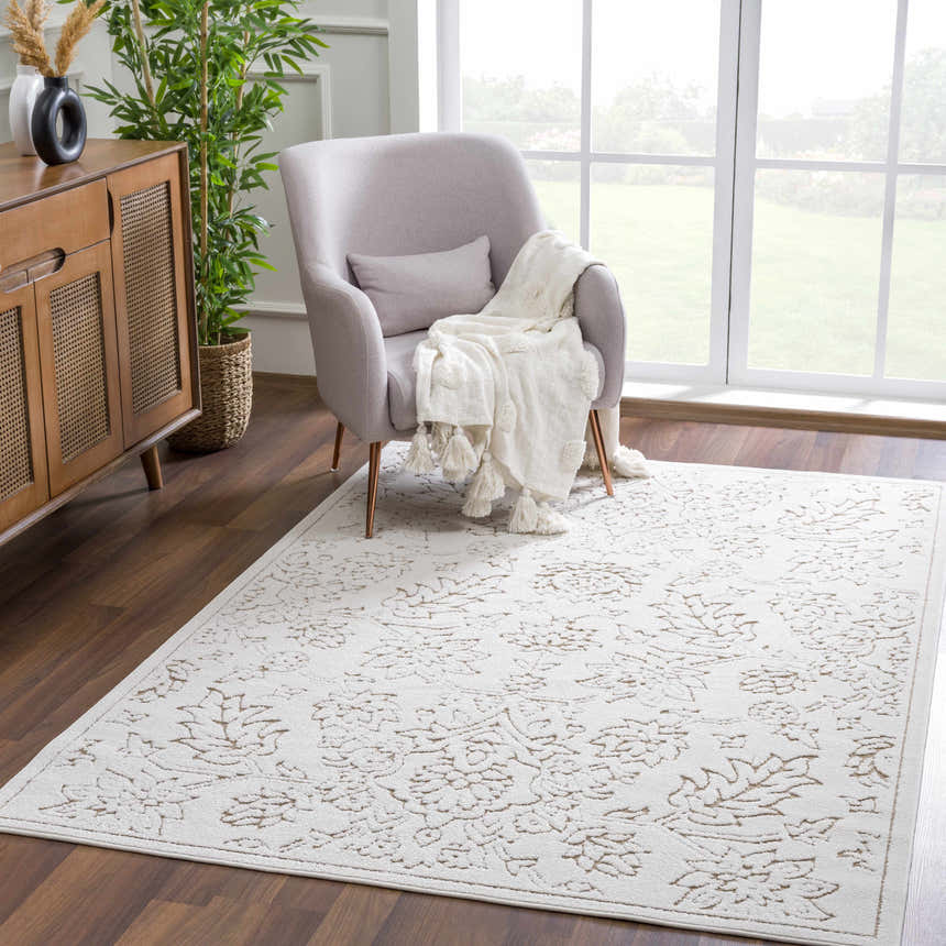 Coastal living room with a light peach chair and the Tabuan 3D Outdoor Area Rug in white thatch and nutmeg. Roomscene-Rectangle