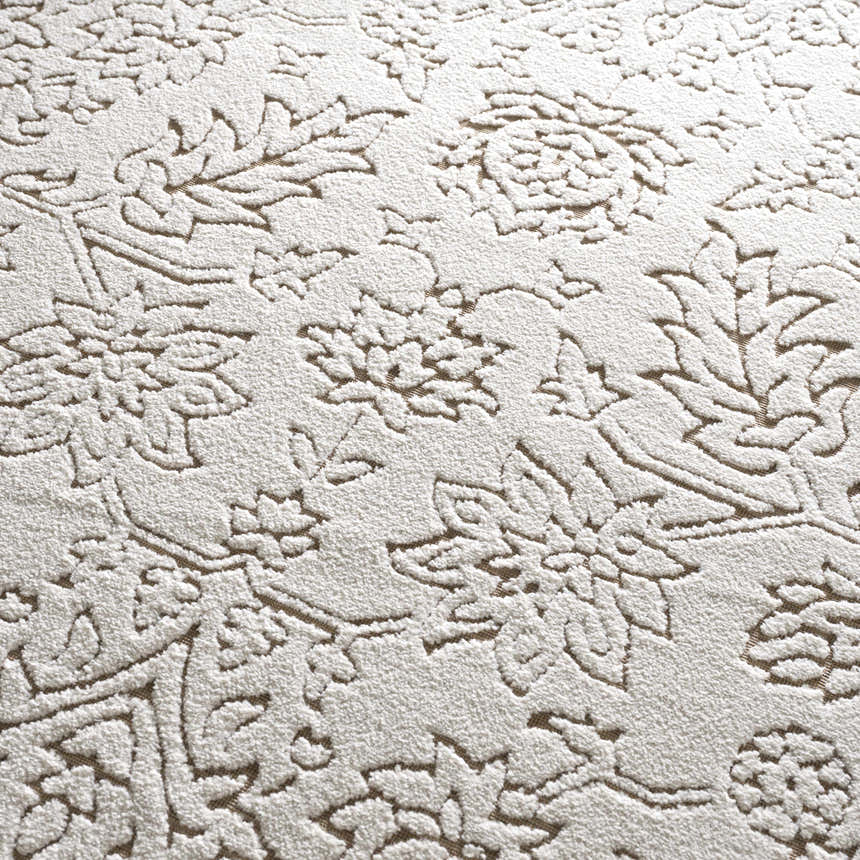 Close-up of the Tabuan 3D Outdoor Area Rug. Floral pattern in white thatch and nutmeg on a gray base. Coastal style. Texture