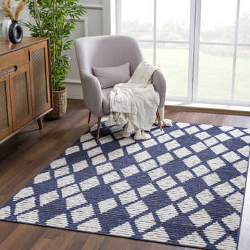 Living room scene with a gray chair on a geometric Bone and Cloud Gray Enhaut 3D Outdoor Area Rug. Roomscene-Rectangle