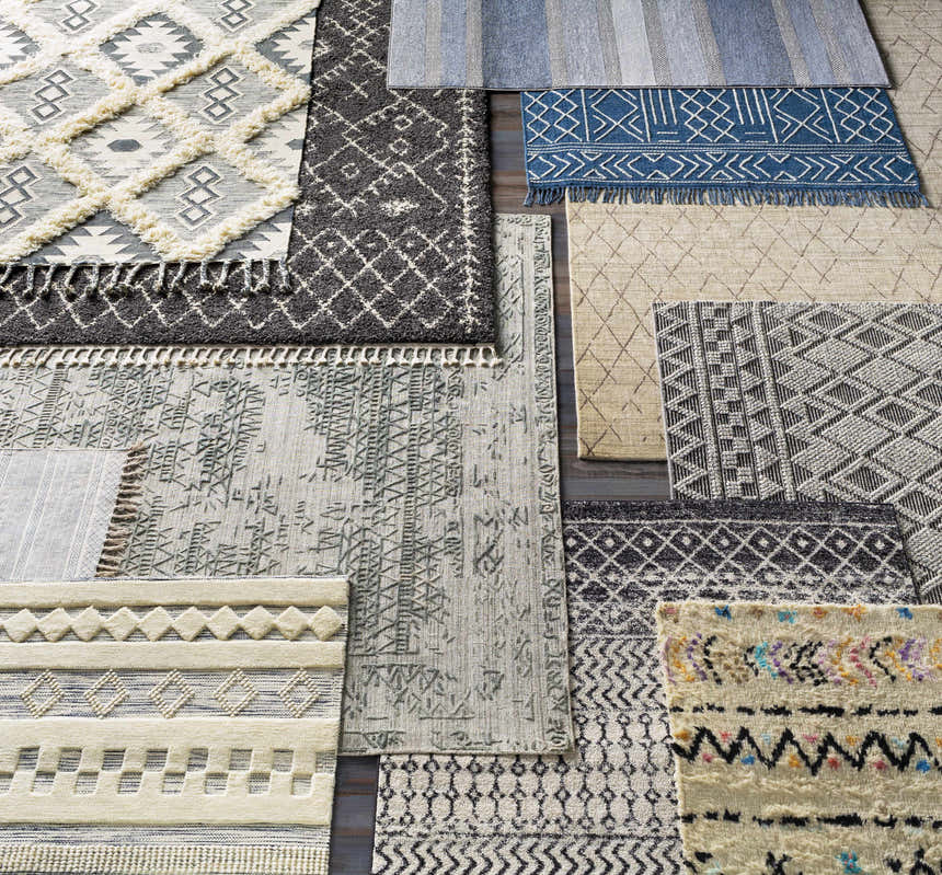 Close-up of assorted area rugs, including the Bonogin rug, showcasing various textures, patterns, and neutral colors. Styleshot