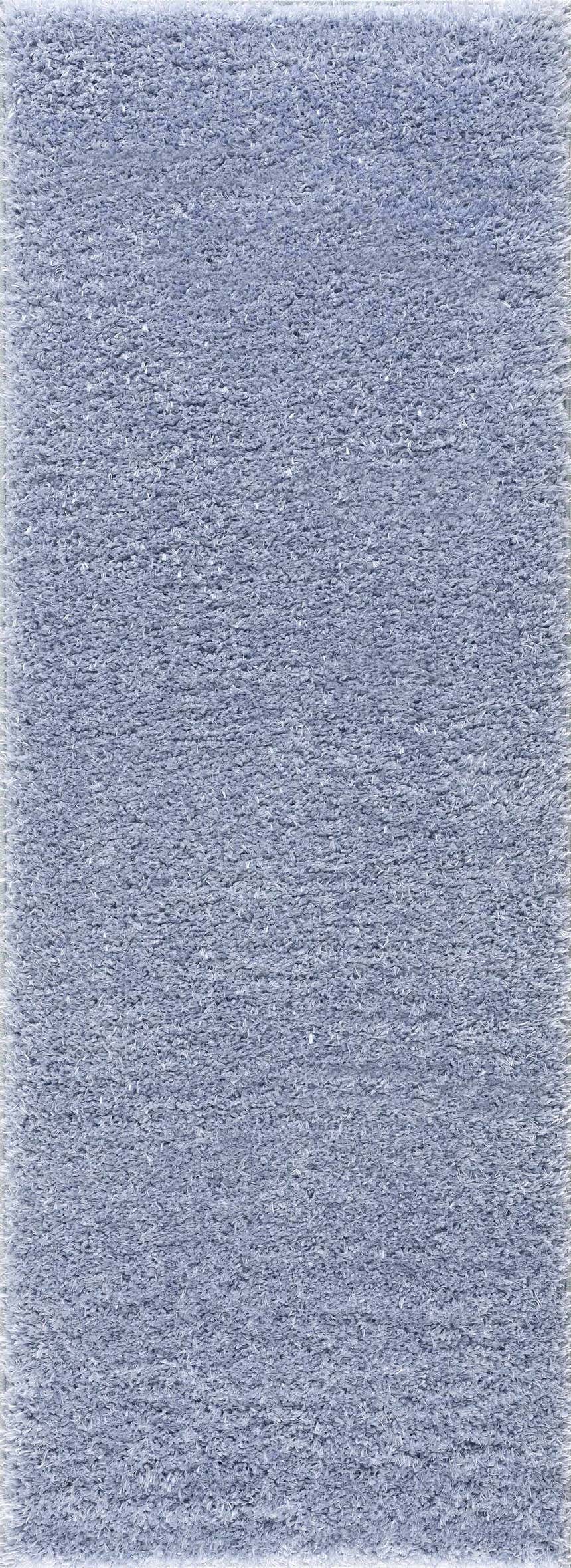 Close-up of the Faina Solid Aqua Shag Washable Area Rug, showing its soft, plush texture and light blue color. Design-Runner