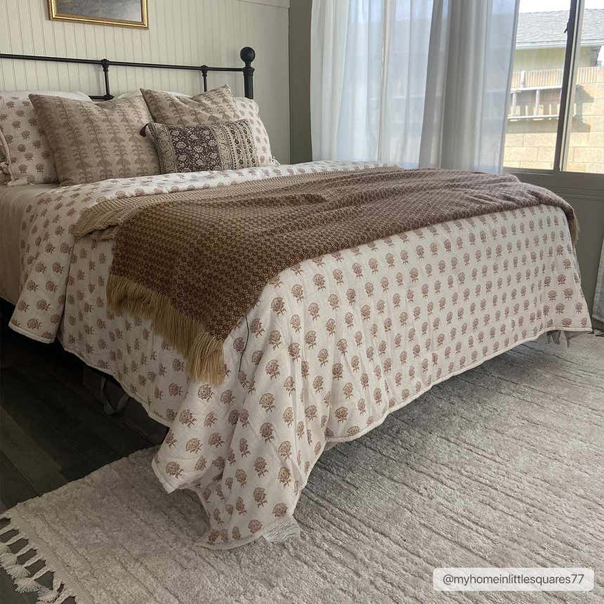 Bedroom scene with Ibarra Textured Ivory High/Low Pile Rug. Farmhouse style with black iron bed and light, airy curtains. Roomscene-Rectangle