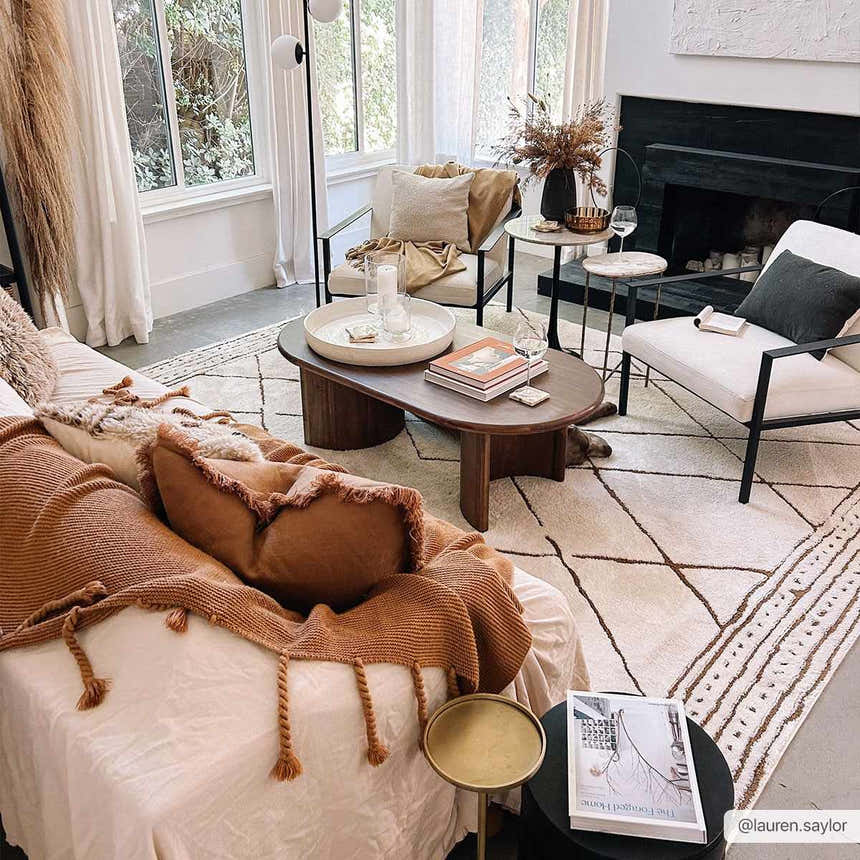 Living room scene with the beige Keone Area Rug, white sofa, wood coffee table, and neutral decor. Roomscene-Rectangle