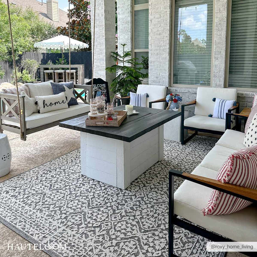 Outdoor patio with swing and Kinglake Area Rug. Black, gray, and white bohemian rug. Roomscene-Rectangle