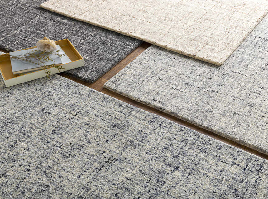 Close-up of Tanana Area Rug in black, cream, and gray wool. Hand-tufted contemporary design with subtle texture. Styleshot