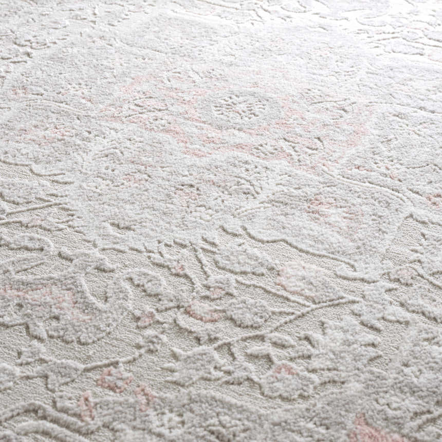 Close-up of the Damla Area Rug, a machine woven rug with a gray and pink vintage floral pattern. Soft texture. Texture