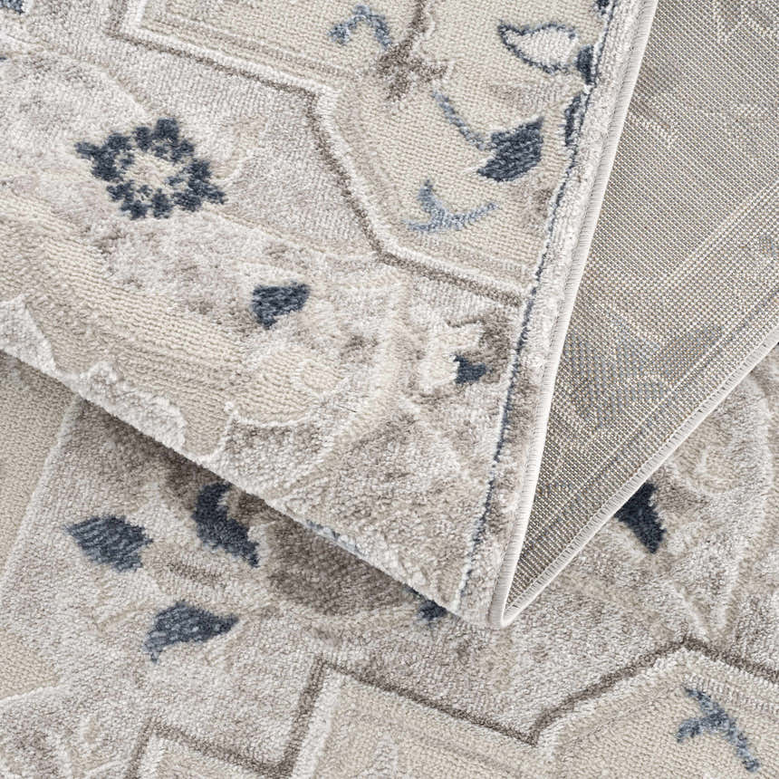 Close-up of the Calum Blue & Gray Area Rug showing its traditional oriental pattern, soft texture, and machine-woven construction. Fold