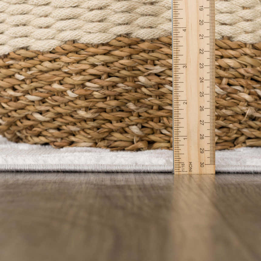Close-up of the thick pile height of the Calum Pink Floral Area Rug, showing texture and construction with a ruler. Pile