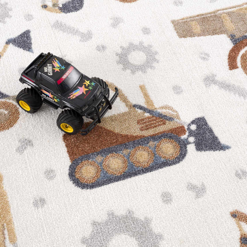 Close-up of Construction Washable Kids Area Rug featuring a playful excavator and gear pattern in blue, brown, cream, and yellow. Styleshot