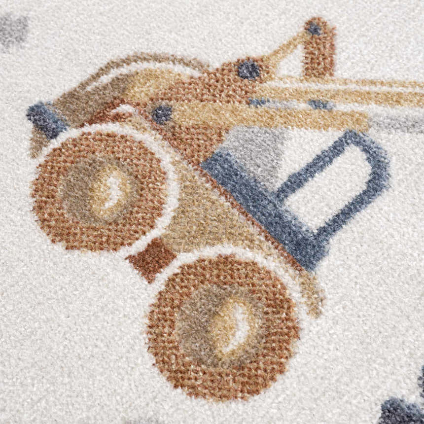 Close up of the Construction Washable Kids Area Rug, featuring a brown and blue truck design on a cream background. Texture
