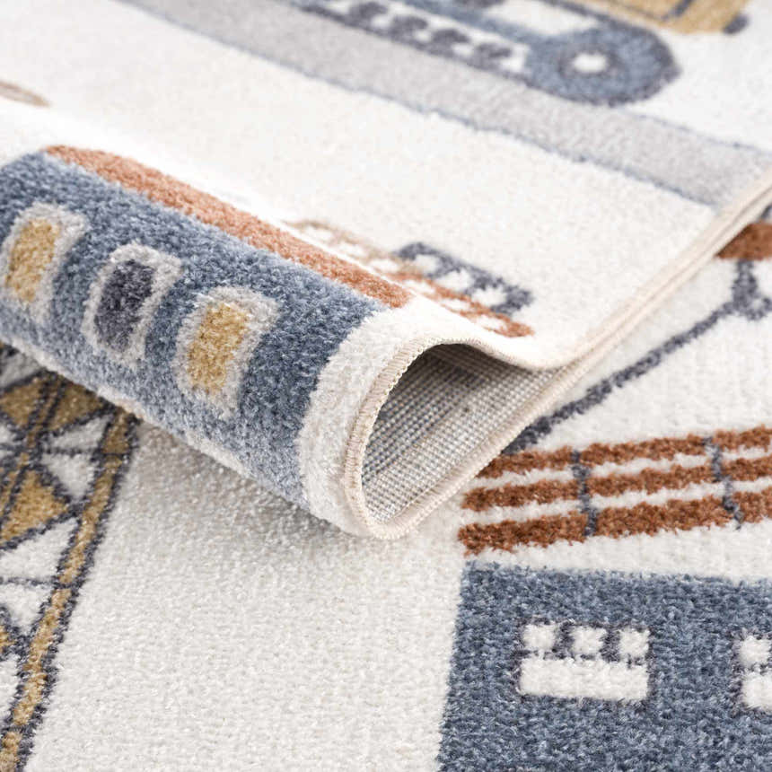 Close-up of the Olwen Washable Area Rug showing its blue, cream, and light gray color palette and soft, machine-woven texture. Fold