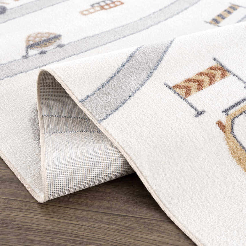 Close-up of the Olwen Washable Area Rug showing the cream, light gray, and blue kids design and machine woven construction. Fold