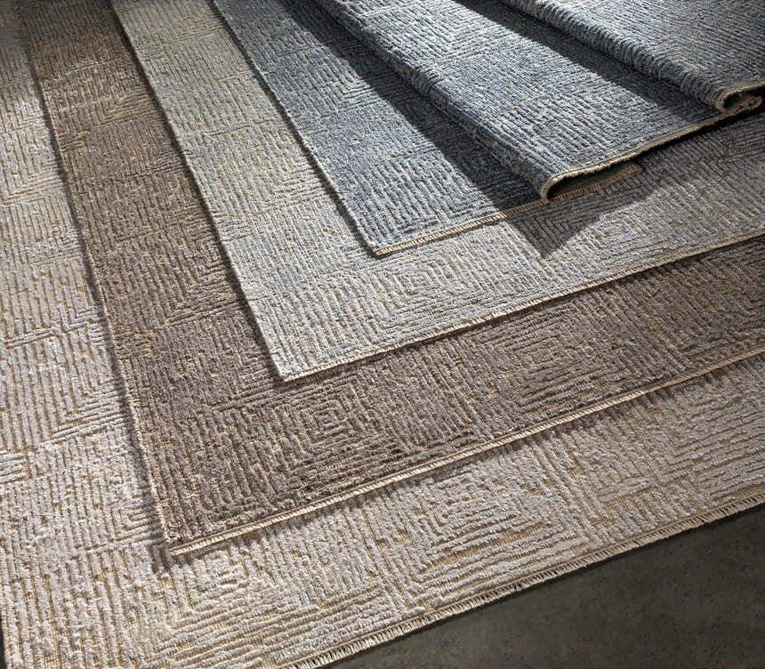 Close-up of the Struie Area Rug showing the oatmeal and gray colors and hand-knotted contemporary design. Styleshot