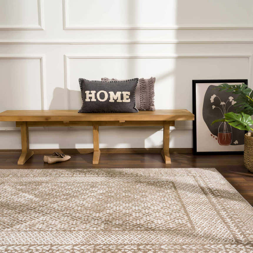 Entryway with a Caditaan Washable Area Rug in brown and cream, wood bench, pillows, art, and wood floors. Roomscene-Rectangle