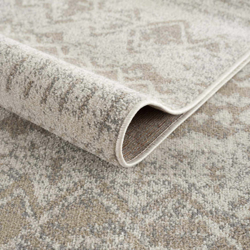 Close-up of Tupsan Washable Area Rug showing its cream, beige, and gray contemporary pattern and machine-woven construction. Fold