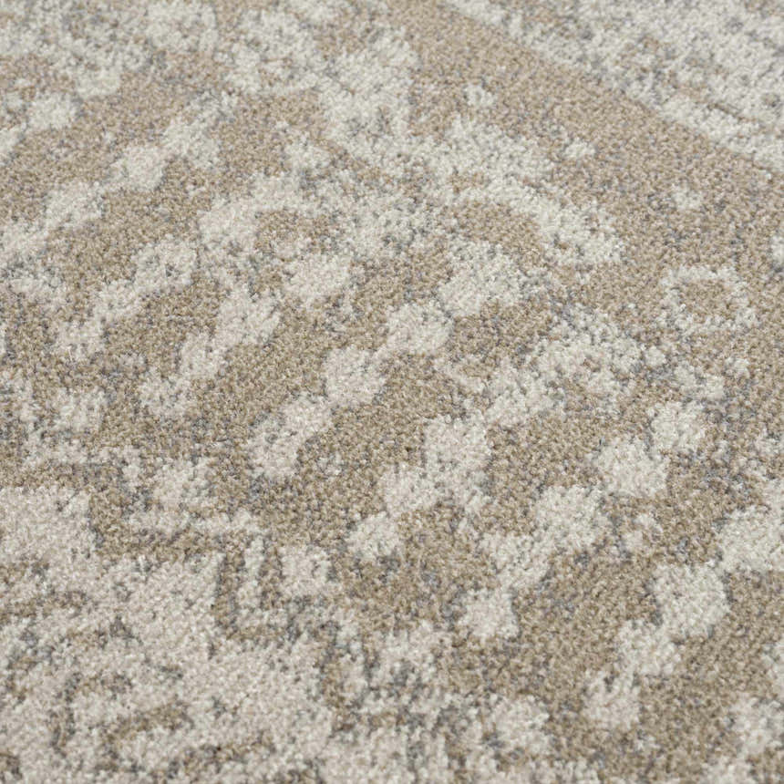 Close-up of the Tupsan Washable Area Rug showing its cream, light beige, and light gray abstract pattern. Texture