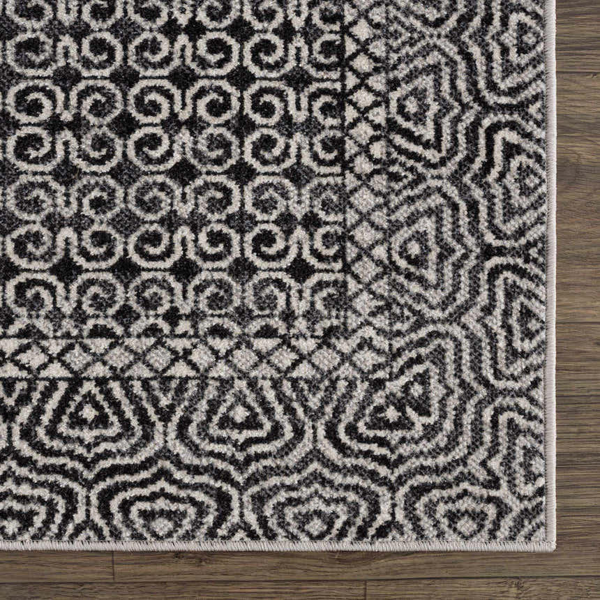 Close up of the Coledale Black & White Washable Rug showing its geometric, farmhouse-style pattern and soft texture. Swatch