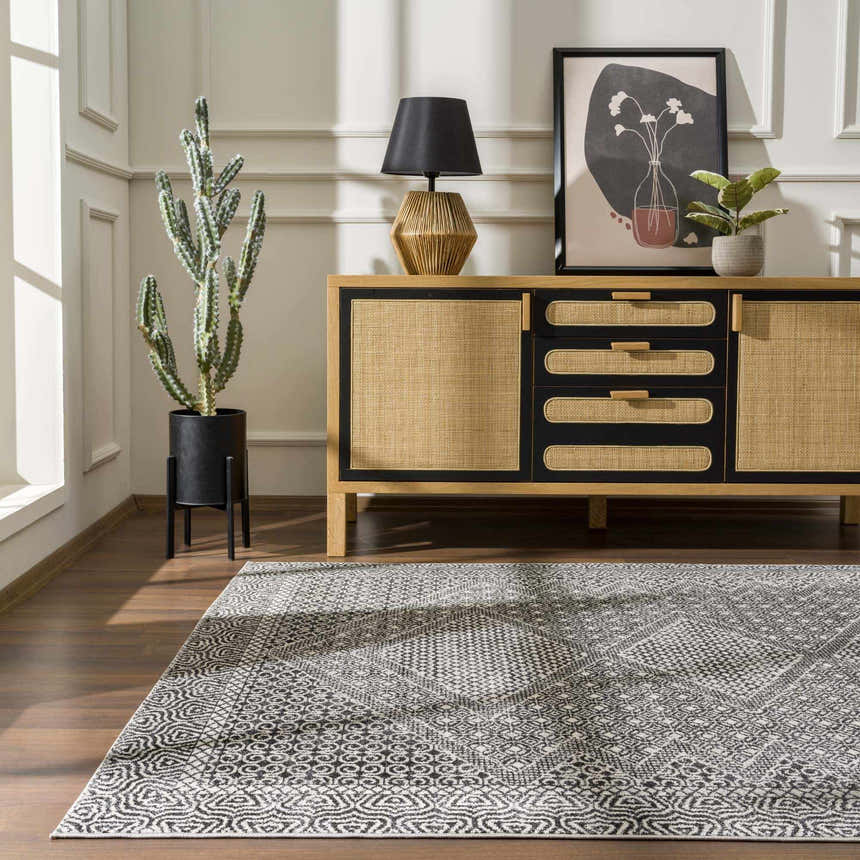 Living room scene with a Coledale Black & White Washable Rug, wood floors, and a tan and black sideboard. Roomscene-Rectangle